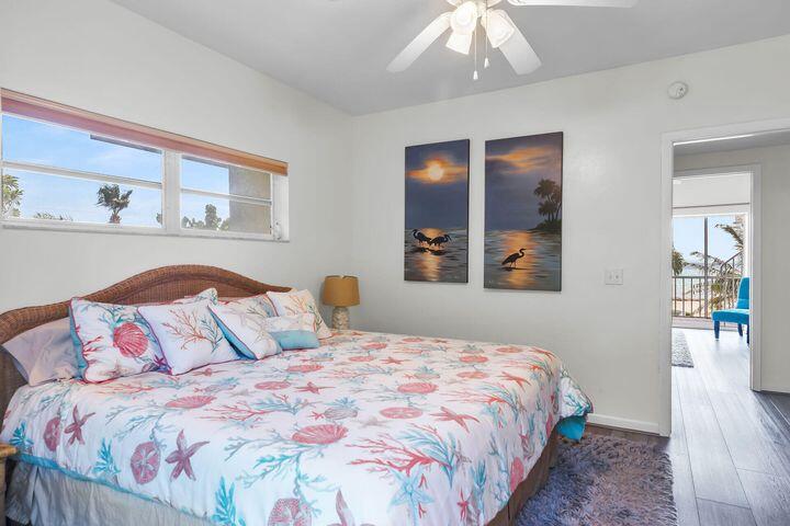140 Aregood Lane, Unit C2 Islamorada, FL 33036 - Photo 27 of 49 a bedroom with a large bed and a chandelier