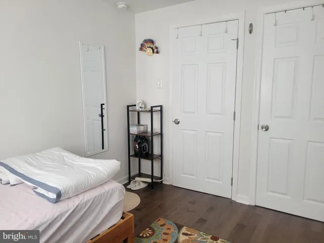 a living room with table chairs and a wooden floor