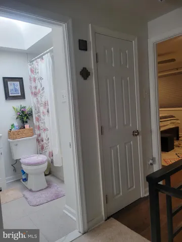 a bathroom with a sink mirror and toilet