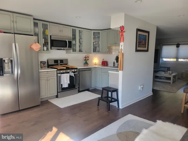 a kitchen with stainless steel appliances kitchen island granite countertop a refrigerator stove microwave and sink