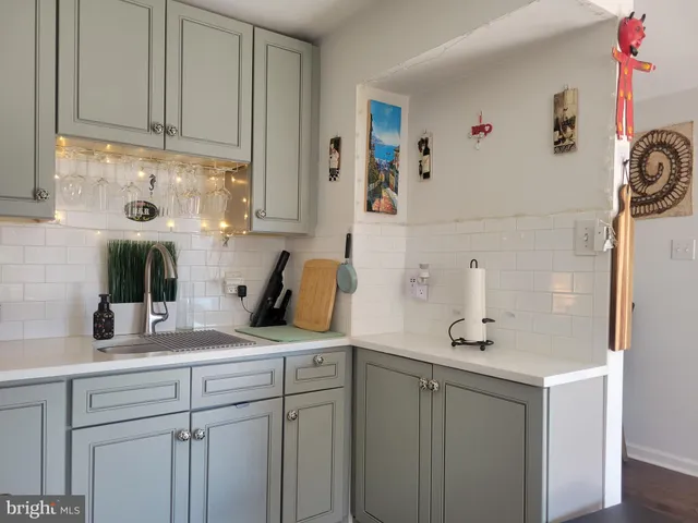 a kitchen with cabinets and window