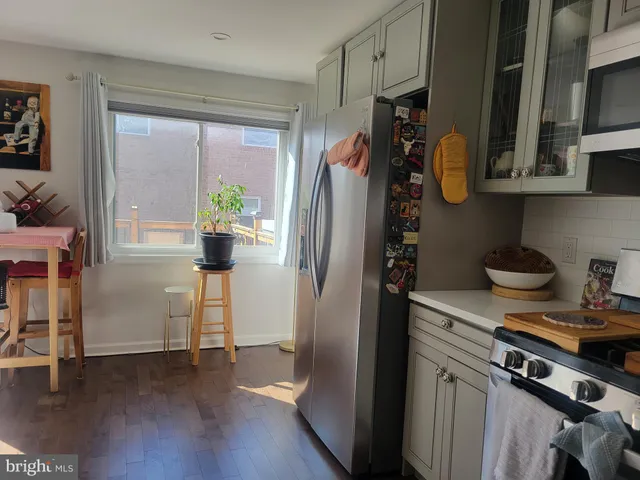 a kitchen with stainless steel appliances granite countertop a refrigerator and a stove