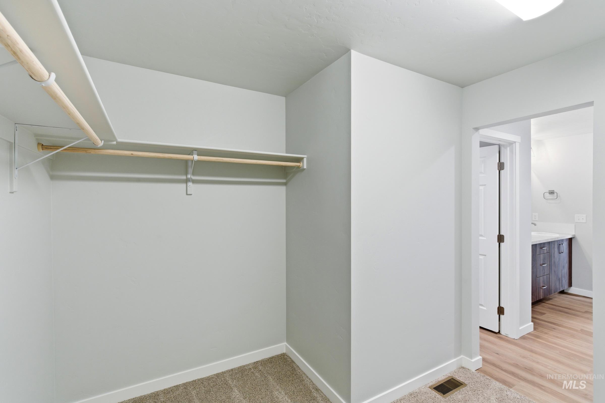 16558 Dunning Way Caldwell, ID 83607 - Photo 27 of 35 Walk-in closet featuring light gray walls, white baseboards, and carpet flooring
