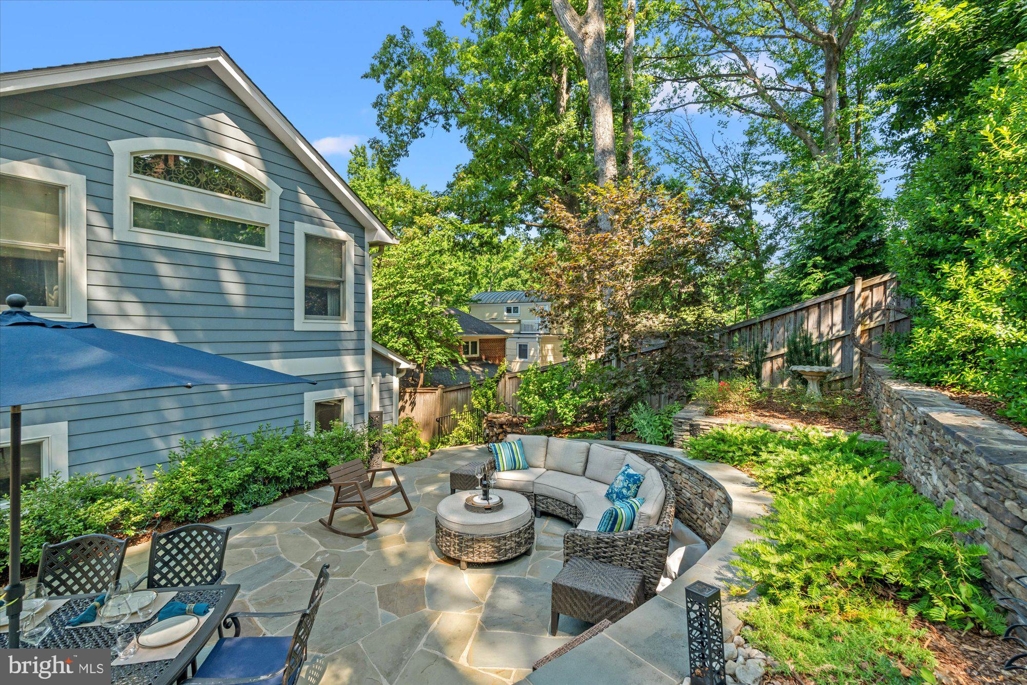 3113 Russell Road Alexandria, VA 22305 - Photo 54 of 64 a view of a backyard with table and chairs potted plants and large tree