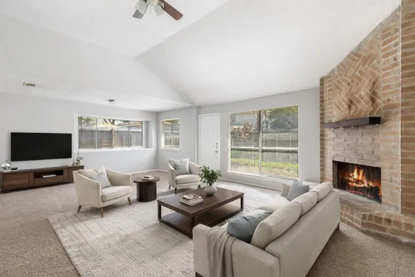 a living room with furniture window and a flat screen tv