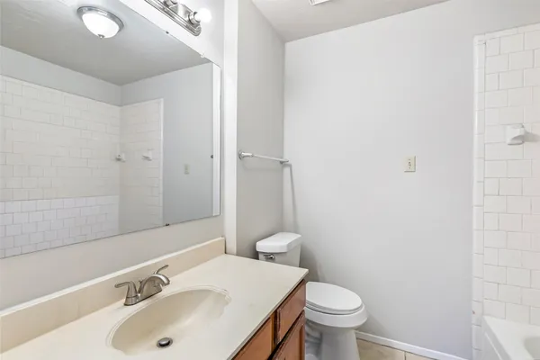 a bathroom with a tub a sink and a window