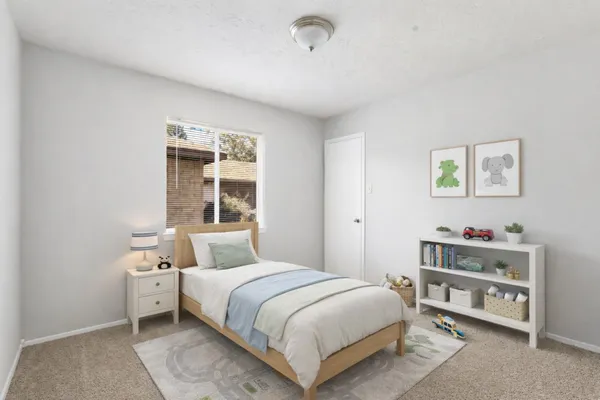a bedroom with a large bed and a potted plant