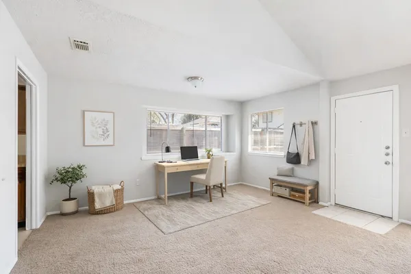 a view of a livingroom with furniture and windows