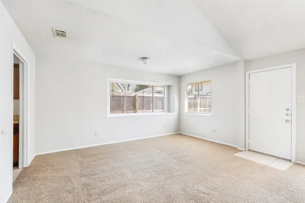 a view of an empty room with a window