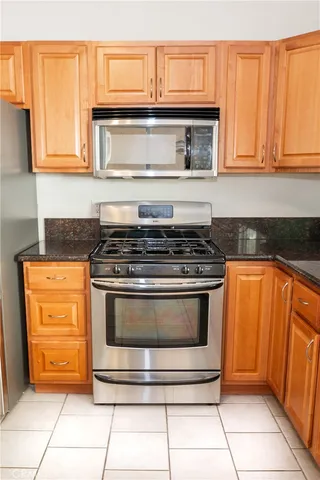a kitchen with granite countertop a stove and a sink