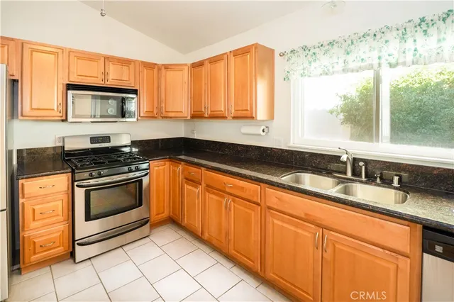 a kitchen with granite countertop a sink and a stove