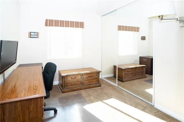 a bedroom with a bed and a chair