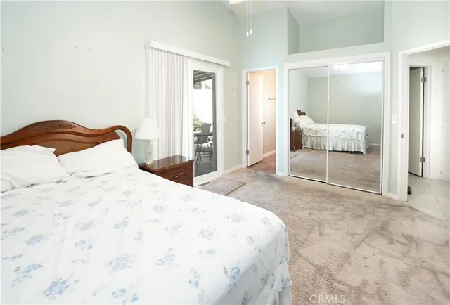 a bedroom with a bed and a mirror