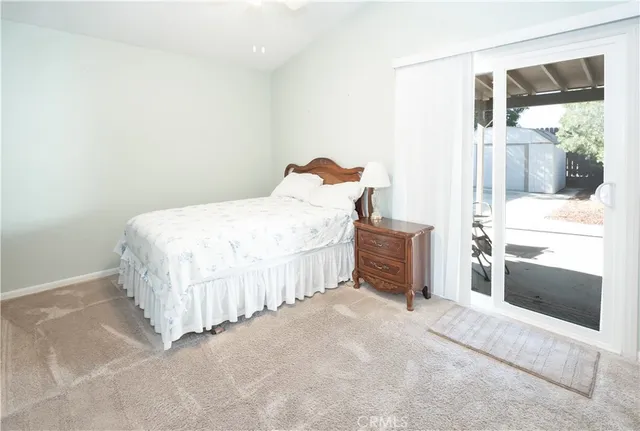 a bedroom with a bed and a large window