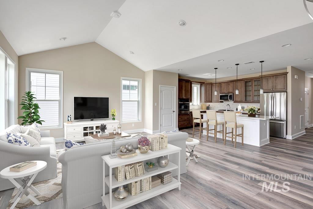 7297 West Lands Street Eagle, ID 83616 - Photo 3 of 5 Living area featuring light wood-style floors, recessed lighting, and vaulted ceiling