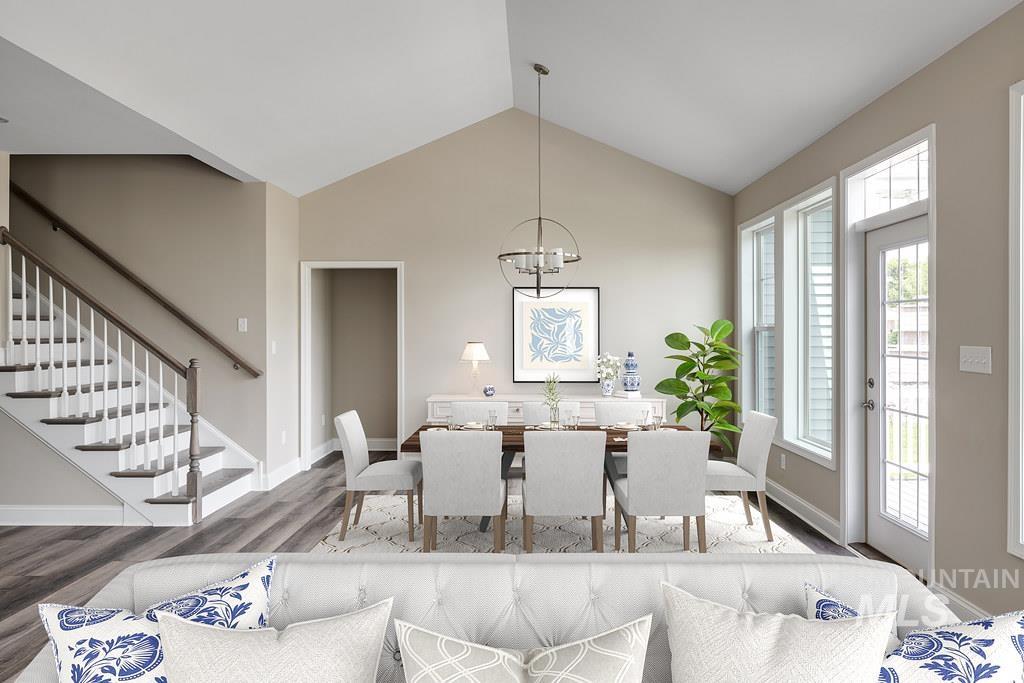 7297 West Lands Street Eagle, ID 83616 - Photo 4 of 5 Dining area with stairs, vaulted ceiling, wood finished floors, and a chandelier