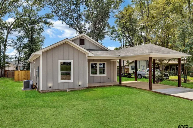 a view of a house with a yard and sitting area