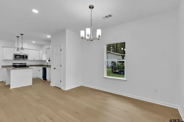 a view of a kitchen with a sink dishwasher and a refrigerator