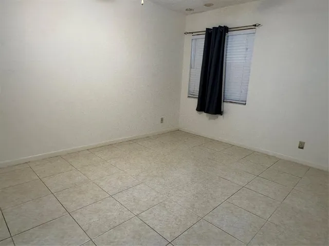 a bathroom with a granite countertop sink a toilet and bathtub