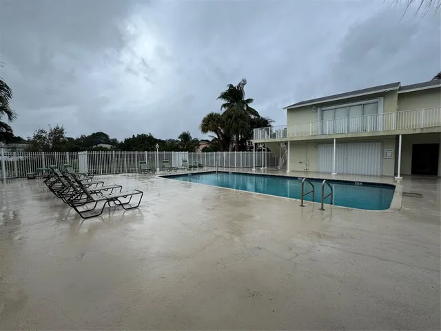 a view of swimming pool is middle in back of house