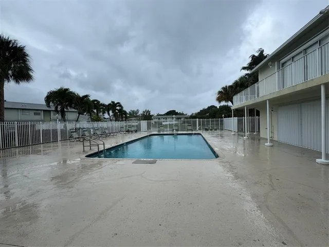 a view of swimming pool with outdoor seating and plants