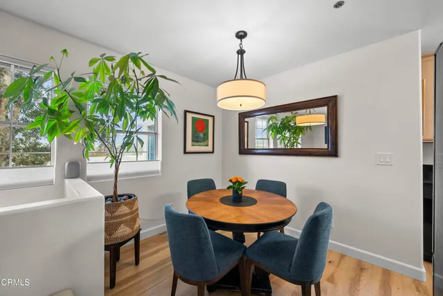 a view of a dining room with furniture window and wooden floor