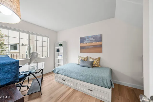 a bedroom with a bed and wooden floor