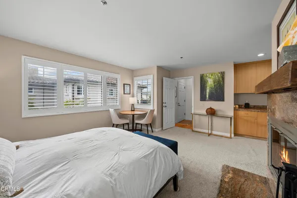 a bedroom with a bed couch and a window