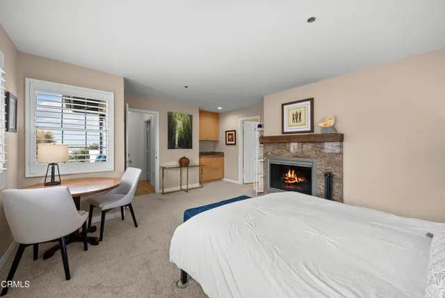 a spacious bedroom with a bed and a table chair