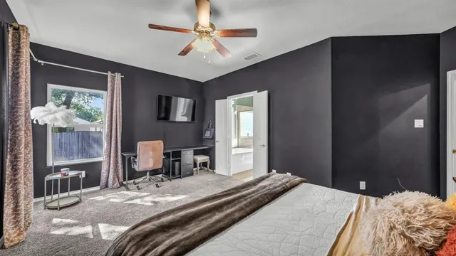 a bedroom with a large bed and a chandelier