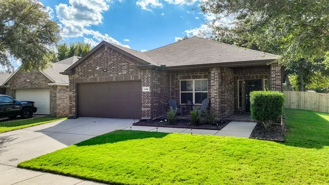 a front view of a house with a yard and outdoor seating