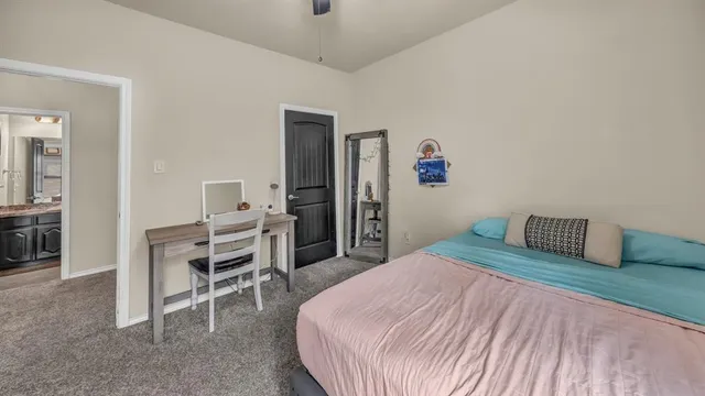 a bedroom with a bed and a chair