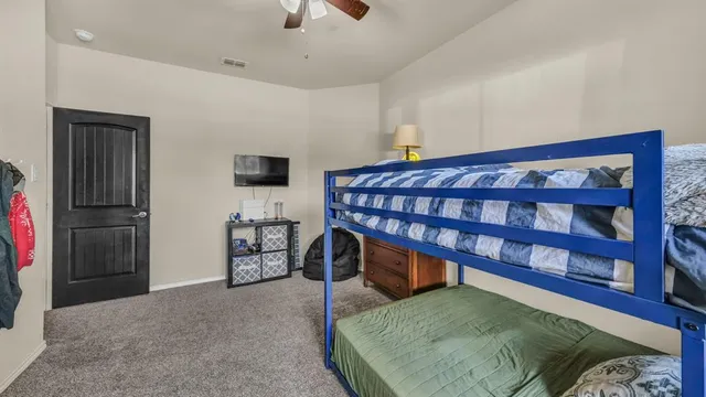 a bedroom with furniture and a flat screen tv