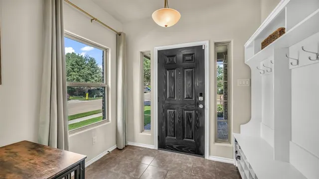 a view of a hallway with bathroom and front door
