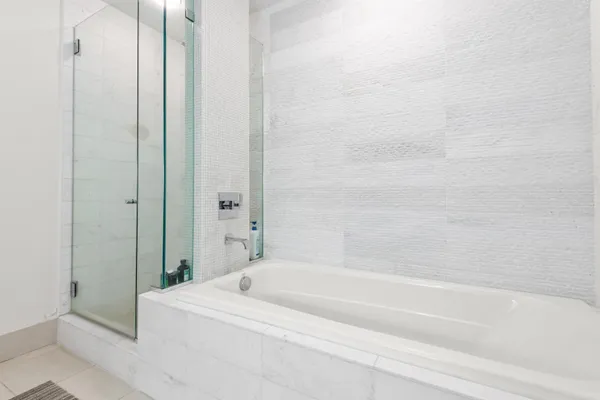 a bathroom with a bathtub and a shower