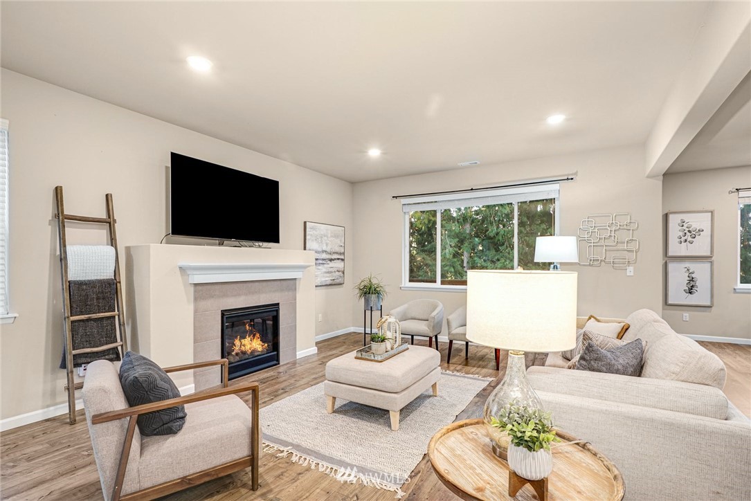 16007 Meridian Avenue South Bothell, WA 98012 - Photo 3 of 35 a living room with furniture fireplace and a flat screen tv