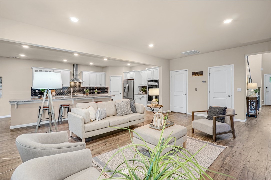16007 Meridian Avenue South Bothell, WA 98012 - Photo 6 of 35 a living room with furniture white walls and kitchen view