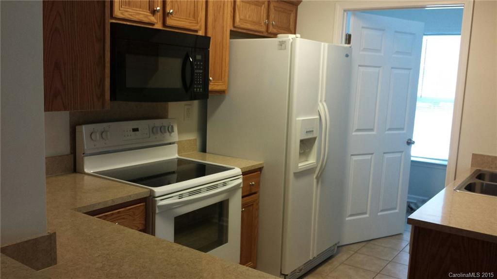 6729 Bevington Ridge Road, Unit A Charlotte, NC 28277 - Photo 4 of 12 a kitchen with a refrigerator sink and microwave