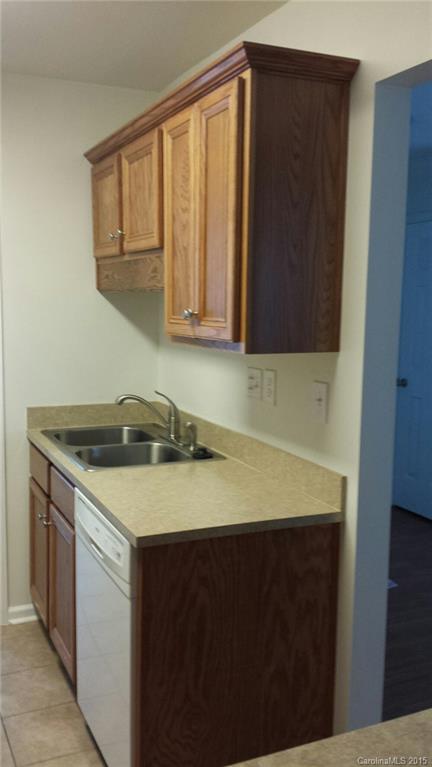 6729 Bevington Ridge Road, Unit A Charlotte, NC 28277 - Photo 5 of 12 a kitchen with a sink and a cabinets