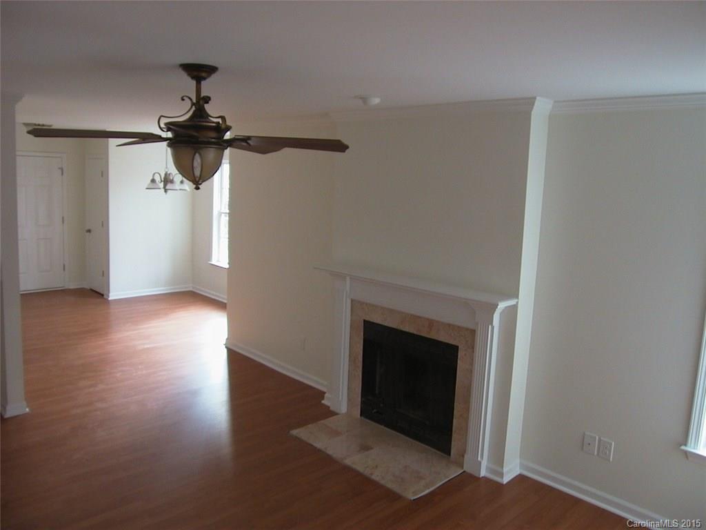 6729 Bevington Ridge Road, Unit A Charlotte, NC 28277 - Photo 7 of 12 a view of empty room with wooden floor and fan