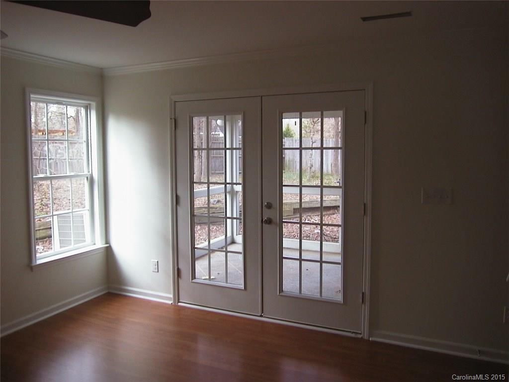 6729 Bevington Ridge Road, Unit A Charlotte, NC 28277 - Photo 8 of 12 a view of an empty room with wooden floor and a window