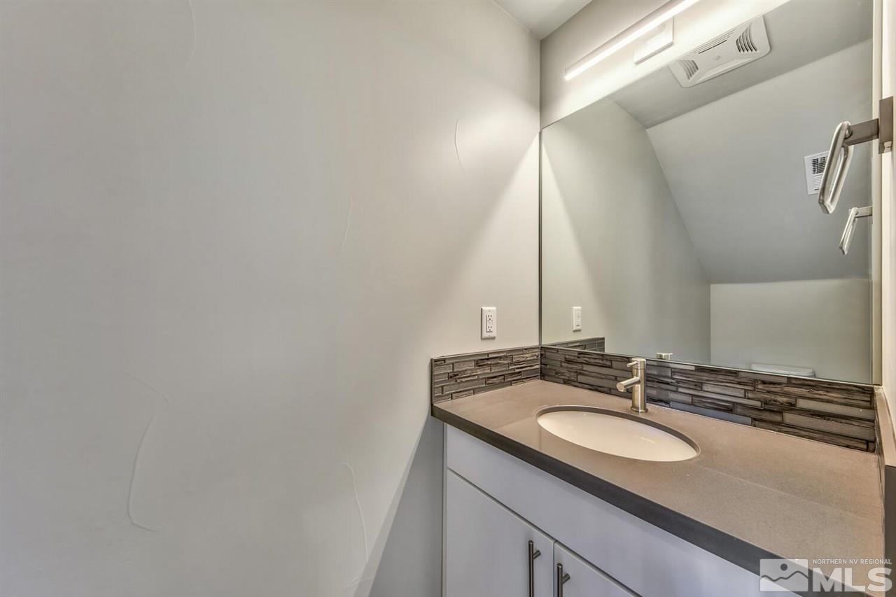 504 Mill Street Reno, NV 89502 - Photo 17 of 22 a bathroom with a sink and a mirror
