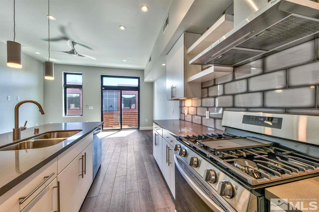 504 Mill Street Reno, NV 89502 - Photo 6 of 22 a kitchen with stainless steel appliances granite countertop a stove and a sink