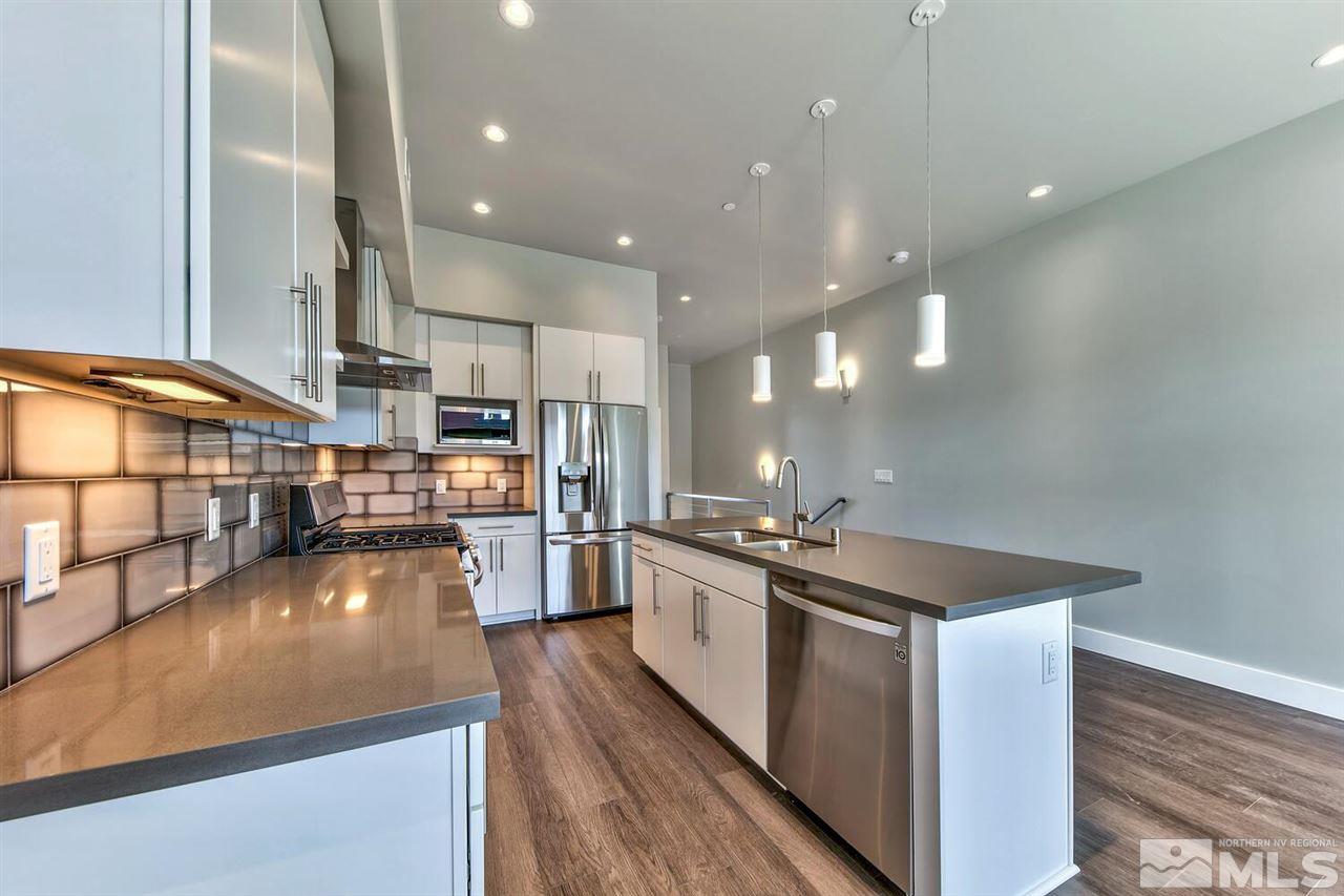 504 Mill Street Reno, NV 89502 - Photo 7 of 22 a kitchen with stainless steel appliances granite countertop a sink a stove and a wooden floors