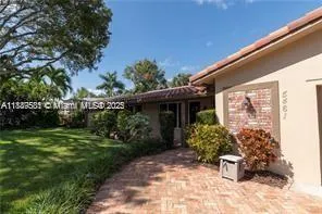 a view of a chair and table in backyard of the house