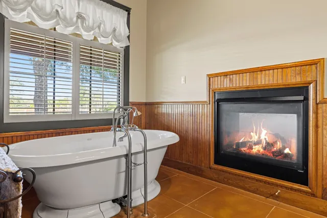 a bathroom with a bathtub and window