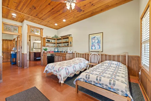 a bedroom with furniture and a large window