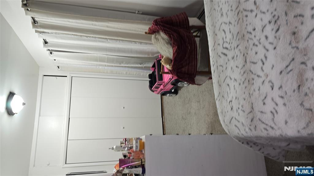 106 Knapp Avenue Clifton, NJ 07011 - Photo 3 of 7 a view of a room with rack and white walls