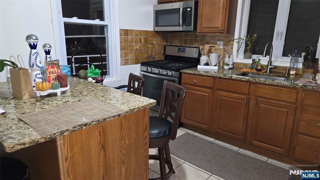 106 Knapp Avenue Clifton, NJ 07011 - Photo 6 of 7 a kitchen with kitchen island granite countertop a stove and a cabinets