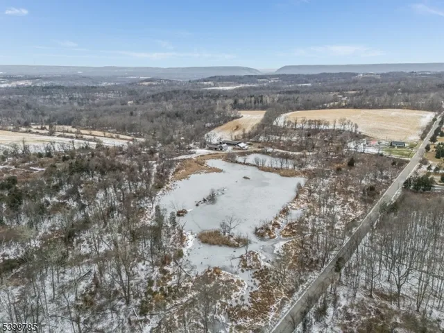 a view of a house with a yard covered with snow in the outdoor space